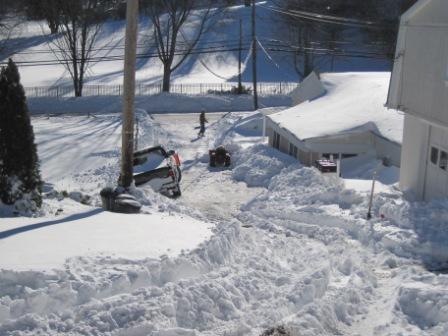 My little stuck truck, left.  Mr. Neighbor's tiny stuck tractor, right. Plowed lower driveway, background.