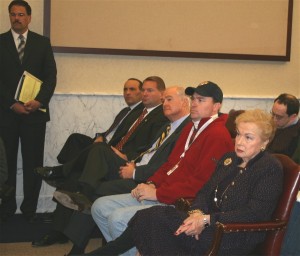 Seated left to right, Freeholder-elect Tom Arnone, Sheriff Shaun Golden, Freeholer John Curley, Freeholder Deputy Director Rob Clifton and Freeholder Director Lillian Burry listen to Goveror Christie's remarks to the press. Standing left, John Tobia, Director of Monmouth County's Department of Public Works