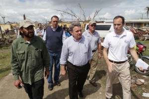 Philippines Country Representative Joe Curry walks with Congressmen Al Green, Trent Franks, and Chris Smith through areas affected by Typhoon Haiyan during a congressional visit to Leyte, Philippines. Photo Credit: Kent Truog