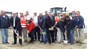 Construction workers, borough council, Mayor Dempsey, Congressman Smith and the U.S. Army Corps of Engineers toss the first official sand of a project that will ultimately see the pumping of 1.5 million tons of off-shore sand back onto the beach.