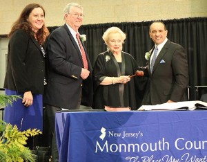 Freeholder Tom Arnone, the 2013 Director, turns over the gavel to 2014 Freeholder Director Lillian Burry. Don Burry, the director's husband, and Assemblywoman Caroline Casagrande look on with approval.