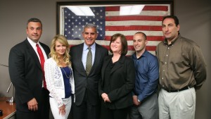 Garry Foltz, Irene Baldassano, Patti Dickens, Michael Fabozzi and Matt Dickens of RAINE present their Leadership Flag to Sen. Joe Kyrillos, center.