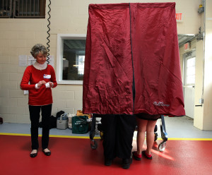 Poll worker Annie Barr stands by while Governor Chris Christie votes for President of the United States with his daughter Bridget, 8, at the Mendham Emergency Services Building in Mendham, N.J. on Tuesday, Nov. 6, 2012. (Governor's Office/Tim Larsen)